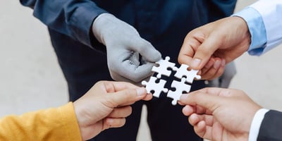 Hands holding puzzle pieces